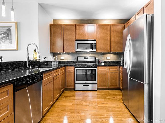Maple cabinets with under counter and upper lighting and newer stainless steel appliances