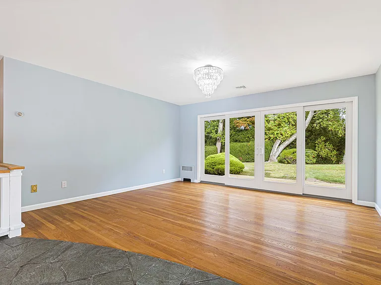 dining room with double sliding glass door to deck and large level yard