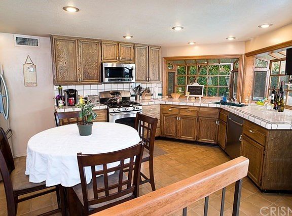 The kitchen is a great focal point of the home which over looks the pool area and is open to the living room, and dining area.