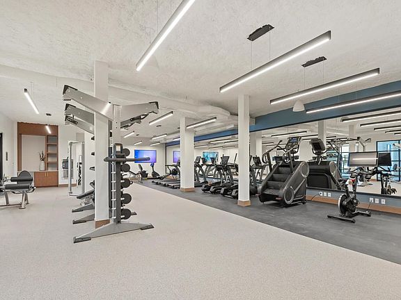 Club-quality fitness studio with TRX station and spin bikes.