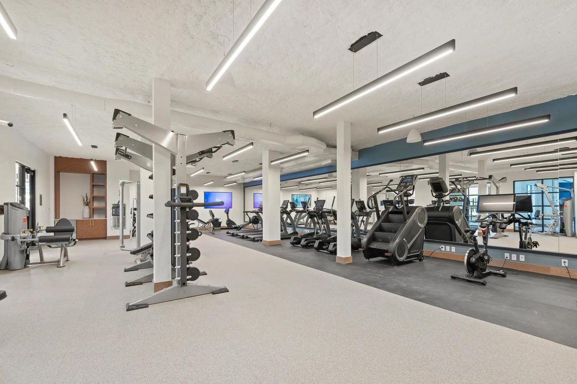 Club-quality fitness studio with TRX station and spin bikes.