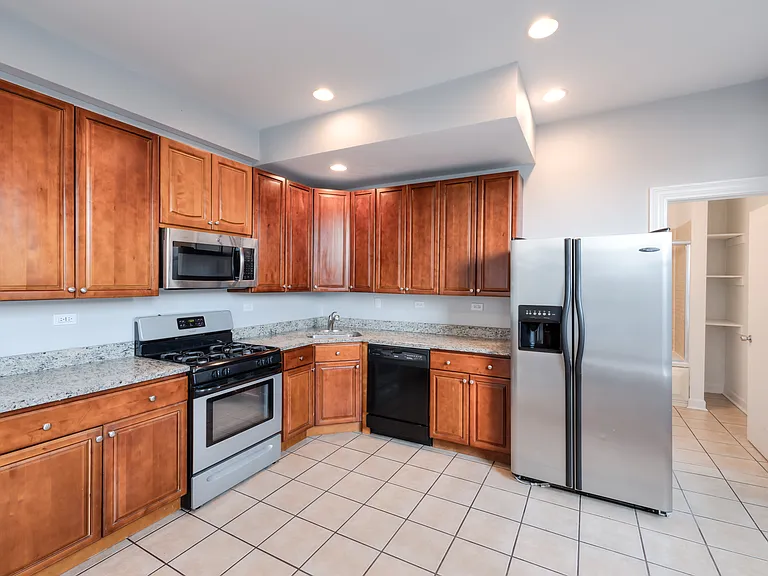 HUGE Kitchen with stainless steel appliances and granite counter tops.