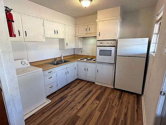 Kitchen with essential appliances, plenty of cabinets, and functional countertop space.