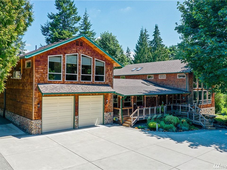 Front view of 4041 sqft  house on 1 acre, dream attached 4+ car garage, detached shop for RV & Boat storage in back, basketball/sports court, 2 driveways to property. Full MIL above garage.