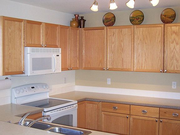 Kitchen with upgraded Light Fixtures, Appliances and Countertops