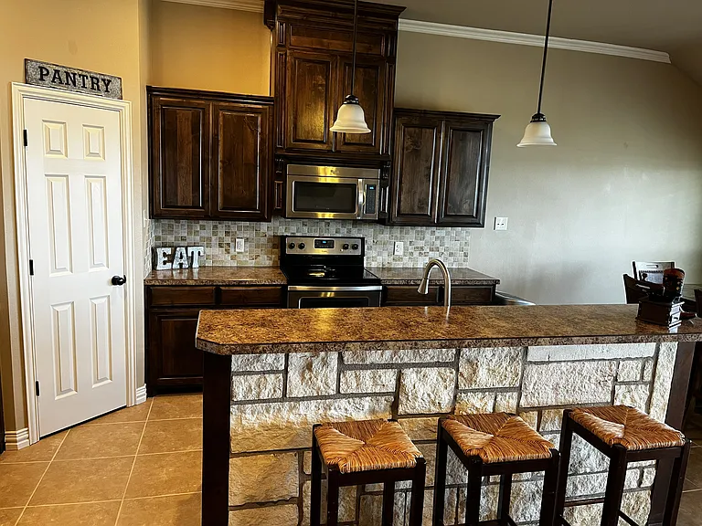 kitchen fully equipped with cookware, small appliances, cutlery, glassware, plates, etc.