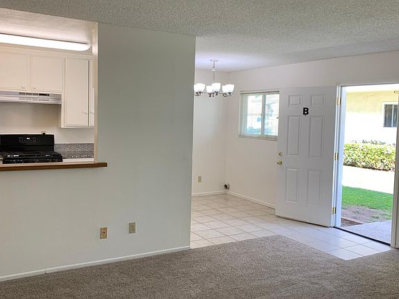 View from living room looking towards kitchen, dining area, and front door.