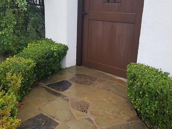 Front entry gate to flagstone paved private courtyard