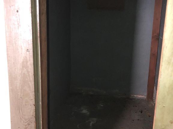 Small enclosed storage area in basement