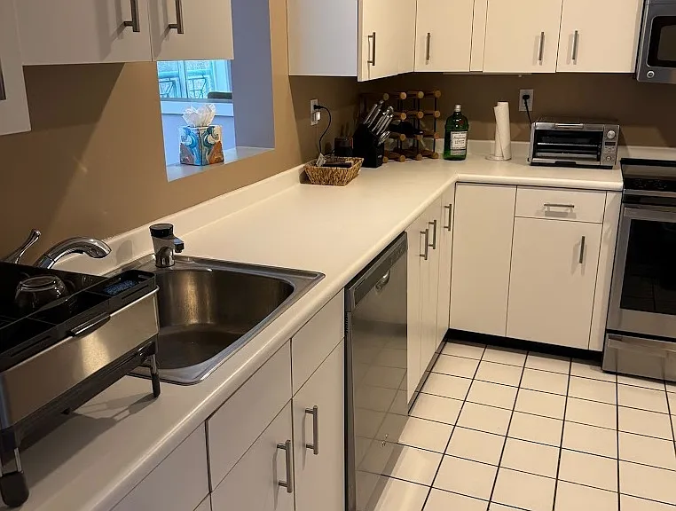 Fully equipped kitchen stocked with dishes, cookware, utensils, and small appliances.