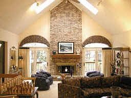 Great Room w/ fireplace, skylights, wet bar and french doors leading to deck