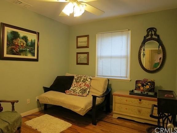 First bedroom with hardwood floors.