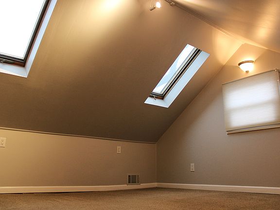 upstairs bedroom with two skylights