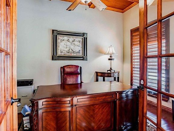 French doors lead you into the study which boosts an oak stained block panel ceiling.  Walls are softly skipped troweled.