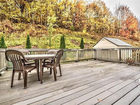 Enjoy your huge deck with the beautiful wooded setting.  Notice the shed conveniently located for your extra lawn furniture and 