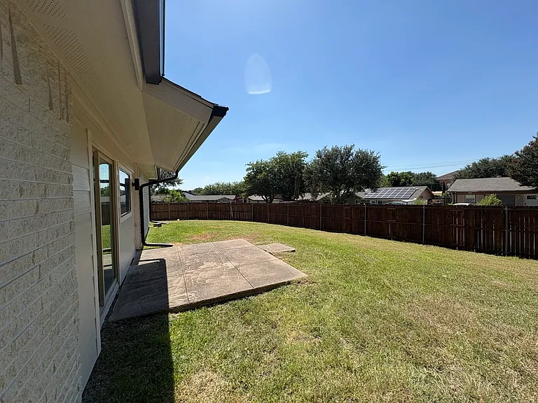 Back porch from kitchen with large yard