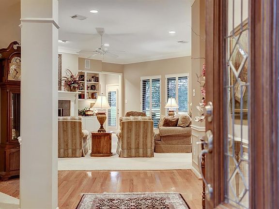 A leaded glass door opens to a warm and welcoming entry.