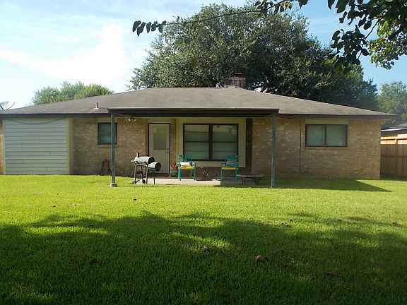 Back view of home and yard