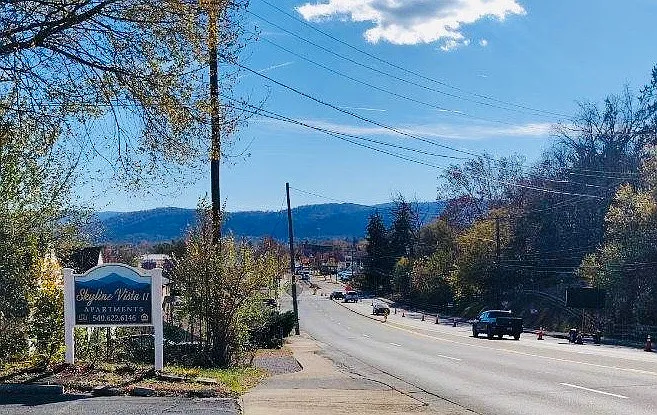 New community sign with a mountain view showcasing the natural beauty surrounding our property.