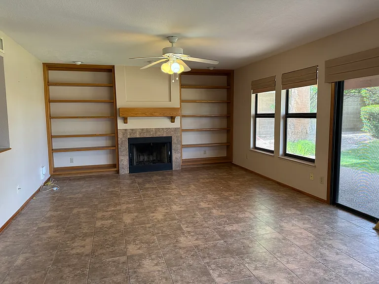 Open family room to kitchen Complete with wood burning fireplace, built ins and ceiling fan