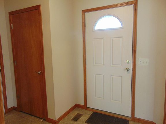 Foyer with coat/boot/storage closet. Garage entry to left.