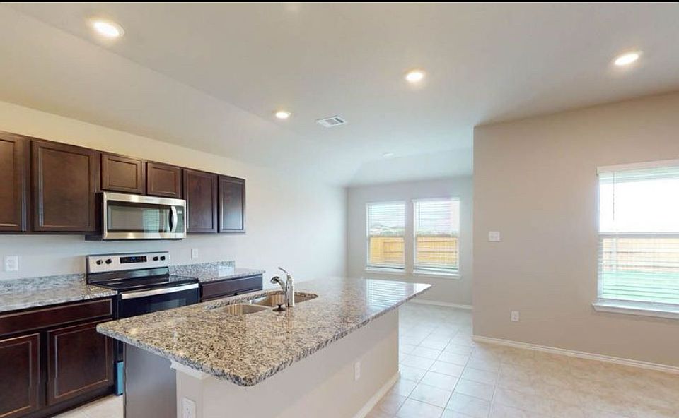 Whip up breakfast at the granite island while sunlight pours in from the backyard view.