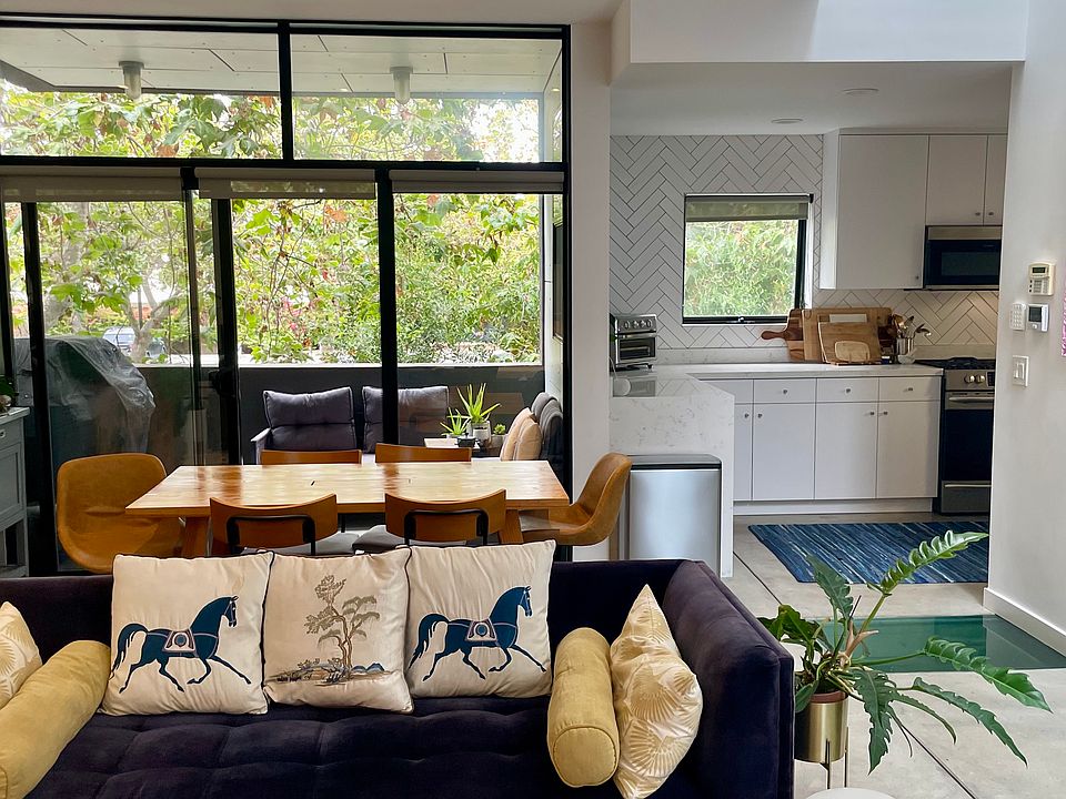 Open living, dining, kitchen + patio w/ gas grill
