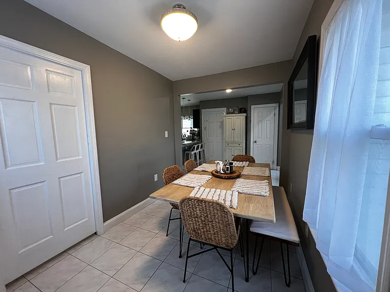 dining room rear view into kitchen area. door on left is into laundry area.