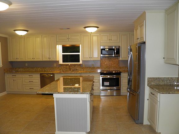 Kitchen with eat in area. Kitchen Island will seat 3 counter stools.