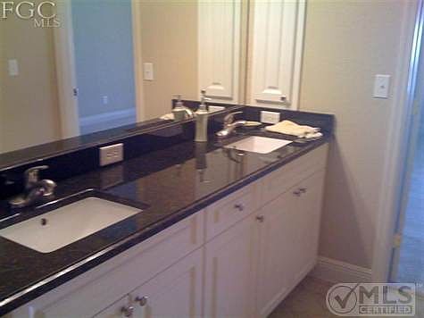 Master bath complete with granite, jetted soaking tub, and newer tiled shower.
