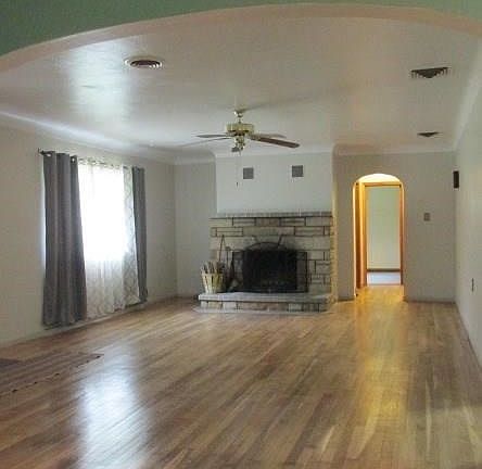 Bright Living Room with hardwood floors and wood-burning fireplace