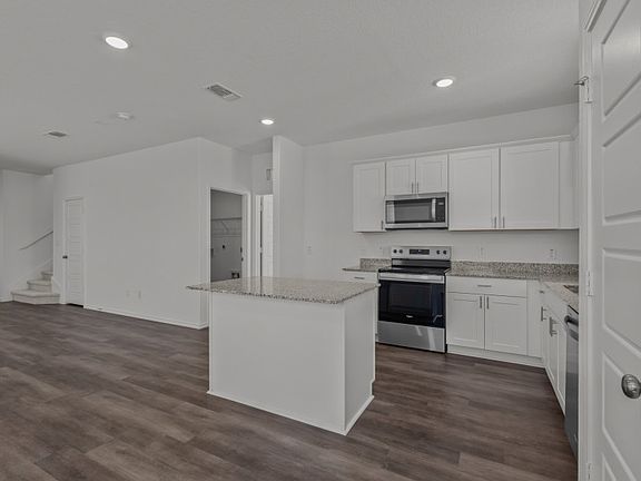 Eat-in island kitchen and abundant cabinet space