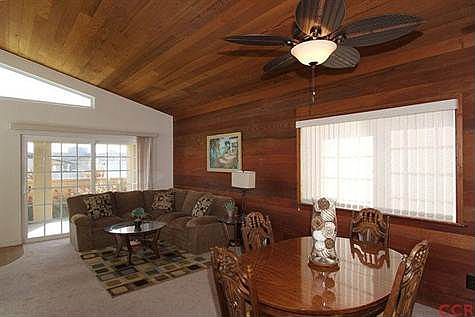 Dining room and living room leading to sliding doors to front courtyard.