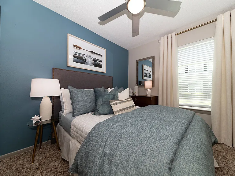 Cozy bedroom with carpet & ceiling fan