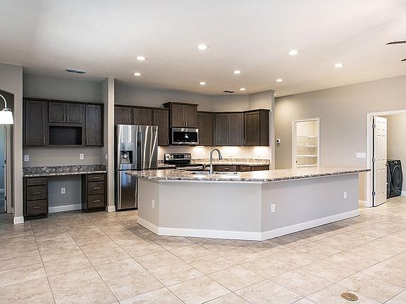 Enjoy a spacious and open kitchen with a built-in desk and your choice of finishes - Wynter with Lof