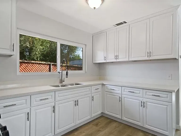 Kitchen counter top and sink with tons of storage.