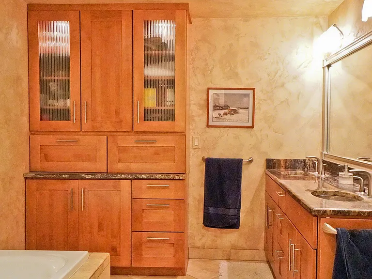 master bath with jet tub and shower, custom built cabinet