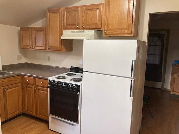 Kitchen has an electric stove/oven and full size refrigerator.