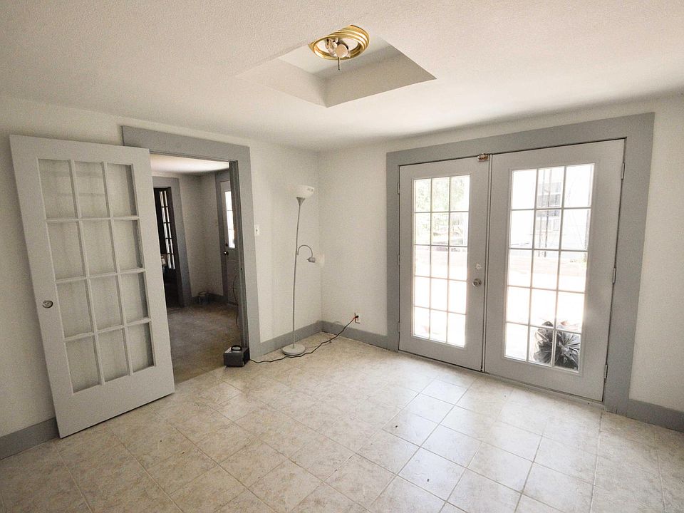 spacious bedroom with on suite bathroom and french door leading to the patio area.
