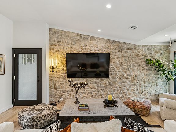 Stone Wall at Living Room - door into finished air conditioned garage
