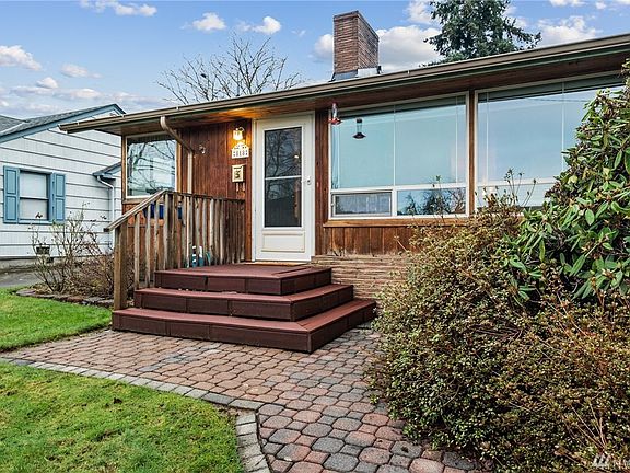 Brick planter box in front of house is ready for your personal touch! 