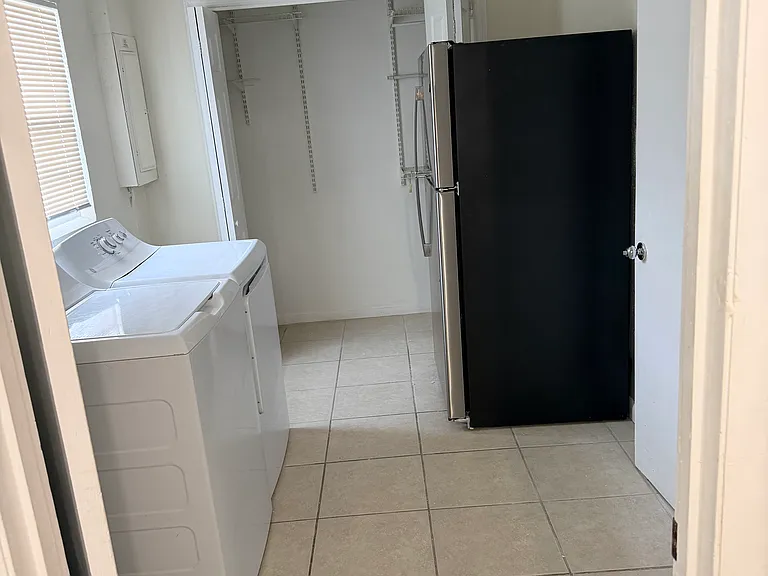 Laundry room with additional refrigerator