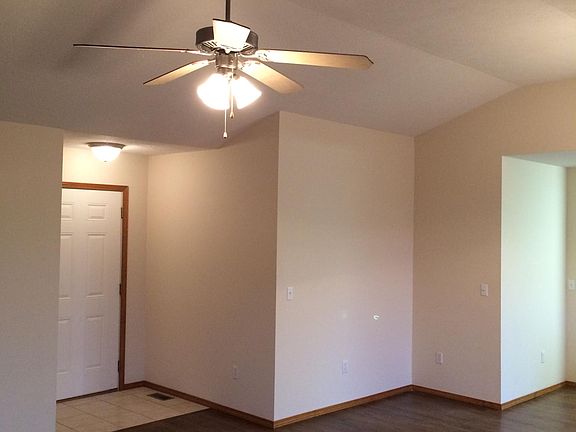photo of great room raised ceiling and fan, wall in Dining area for hutch or serving table