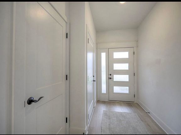 Elegant front door with contemporary detailing, offering a stylish first impression and enhanced curb appeal.