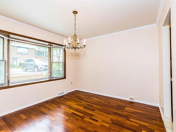 Imagine entertaining in this 12 x 11 dining room with crystal chandelier and large bay window!
