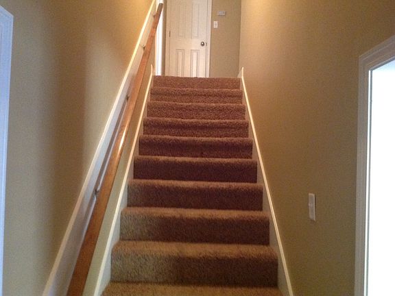 Stairs leading upstairs to 2 bedrooms and bath
