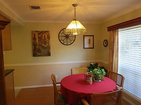 Formal dining room has a nice view of the lush landscaping