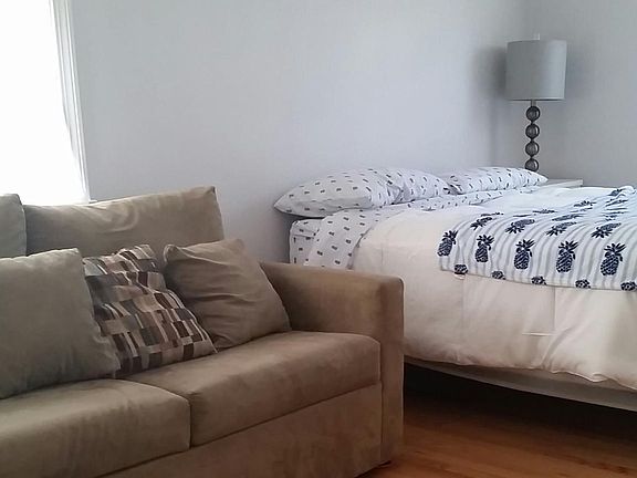 view from walk in closet of room pull out couch and bed