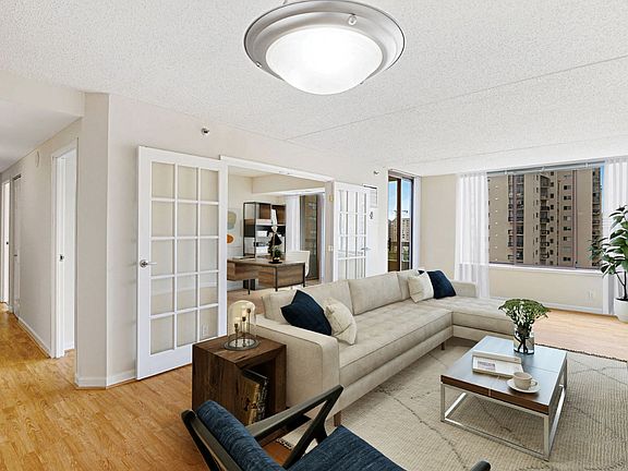 Apartment living area with den (virtually staged)