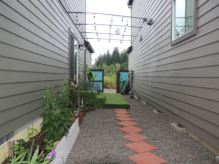 Side yard with raised bed and premium artificial grass turf